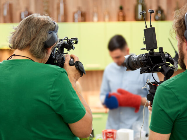 Behind the scenes of filming films or video products and the film crew of the film crew on the set in the pavilion of the film studio.