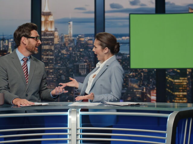 Charismatic tv hosts discussing mockup news evening closeup. Reporters talking