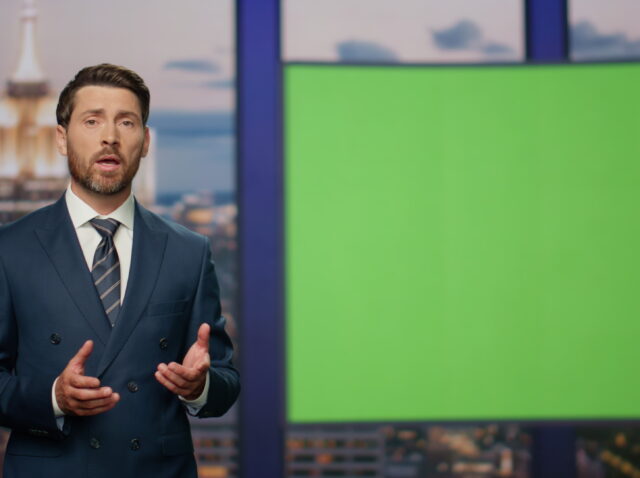 Elegant host reporting breaking news standing near green screen close up.