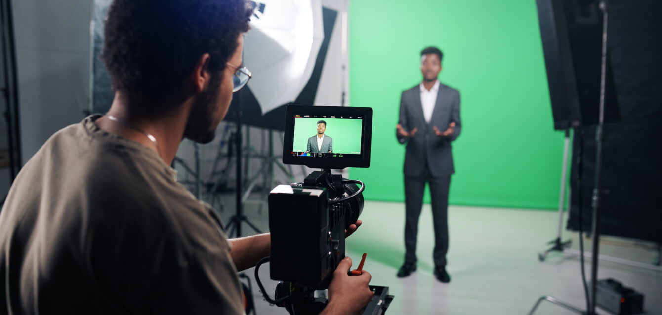 Cameraman using camera to shoot TV program