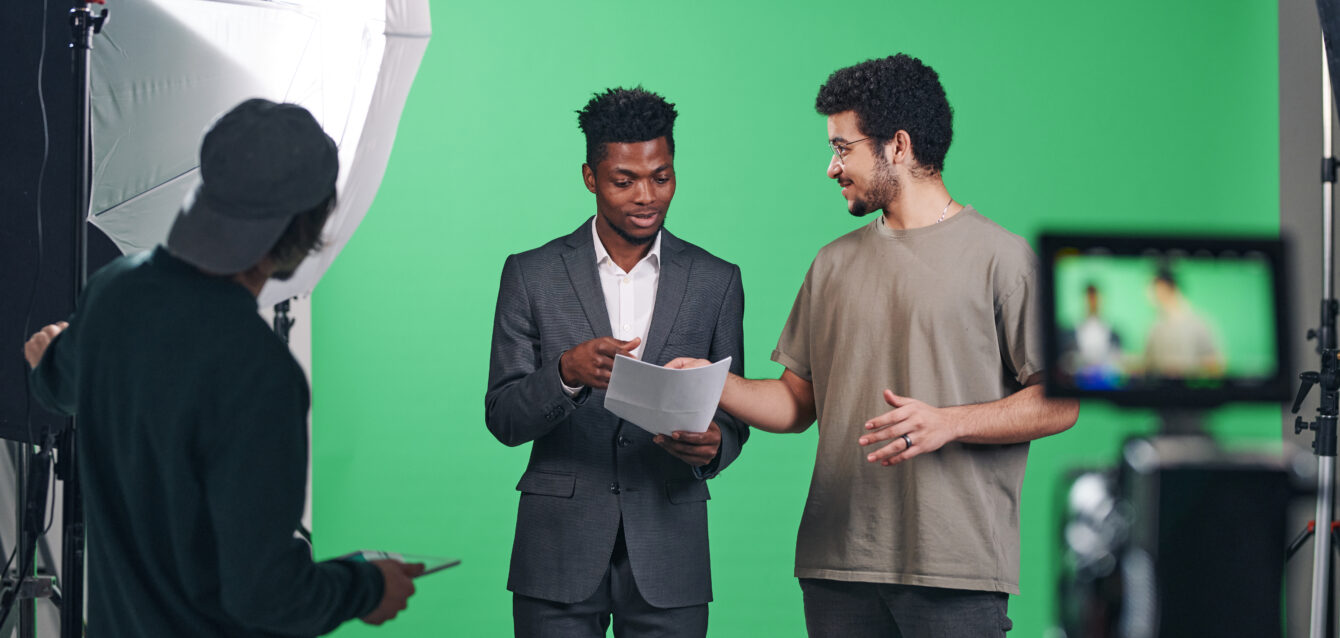 Presenter discussing script with director